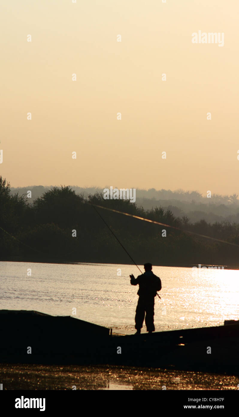 silhouette of fisherman fishing with sunrise in the background Stock ...
