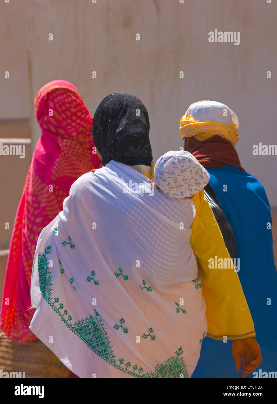 People in colorful attire on the street in old medina, Essaouira, Morocco Stock Photo