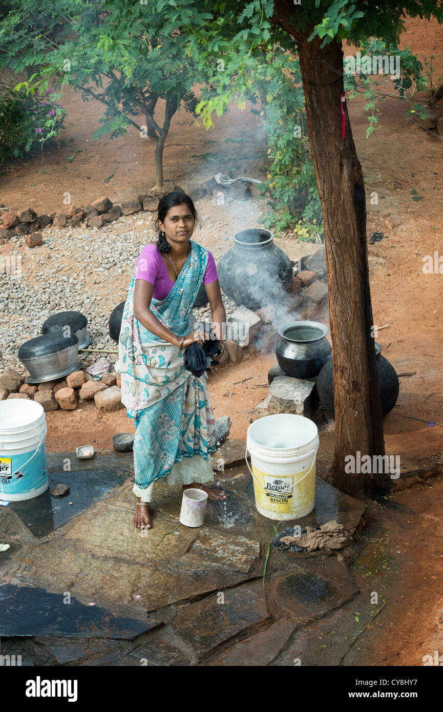 Young Indian woman washing clothes outside her home in a rural indian  village. Andhra Pradesh, India Stock Photo - Alamy