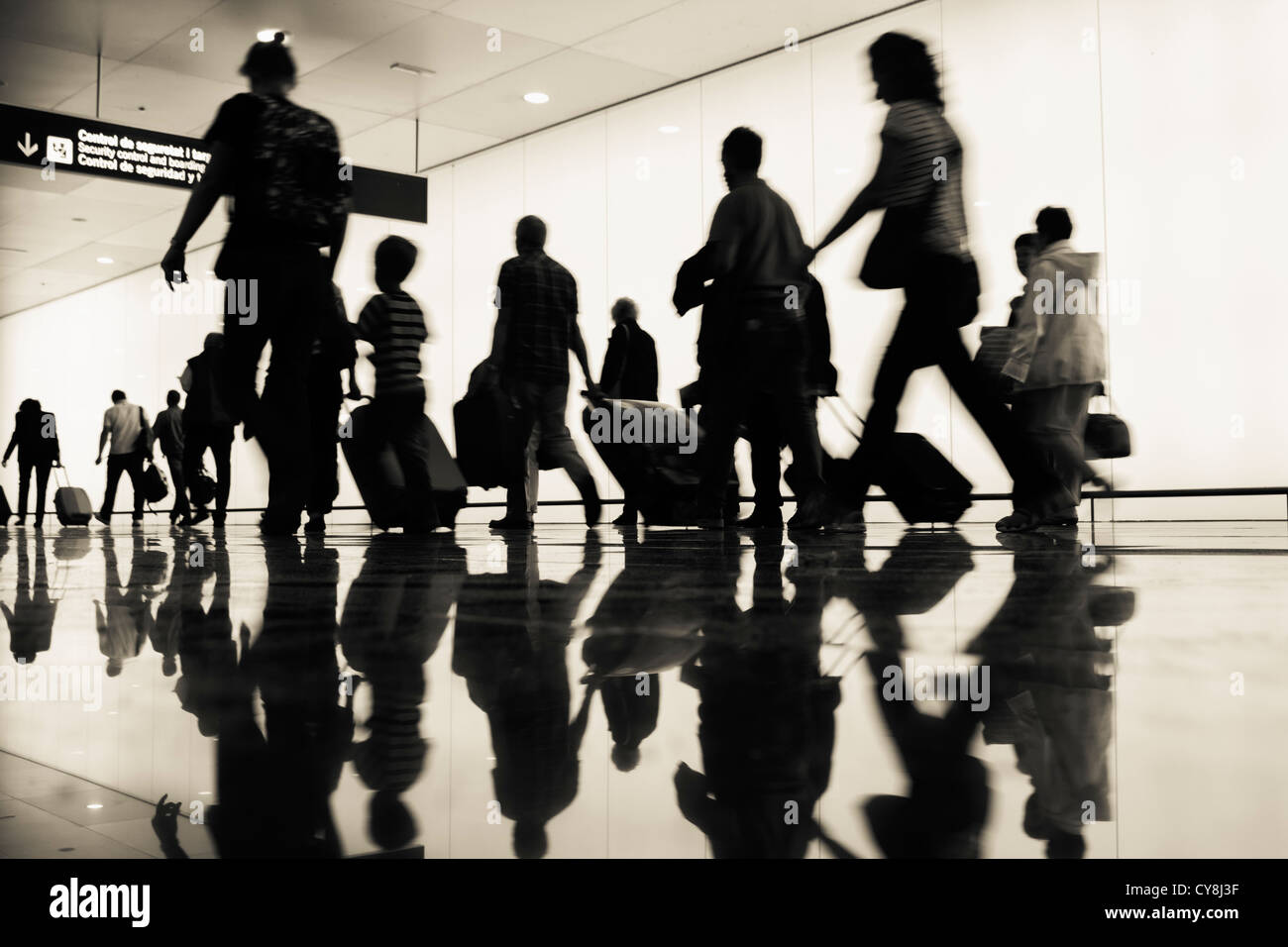 Passengers walking towards boarding gates at El Prat airport. Barcelona, Spain Stock Photo