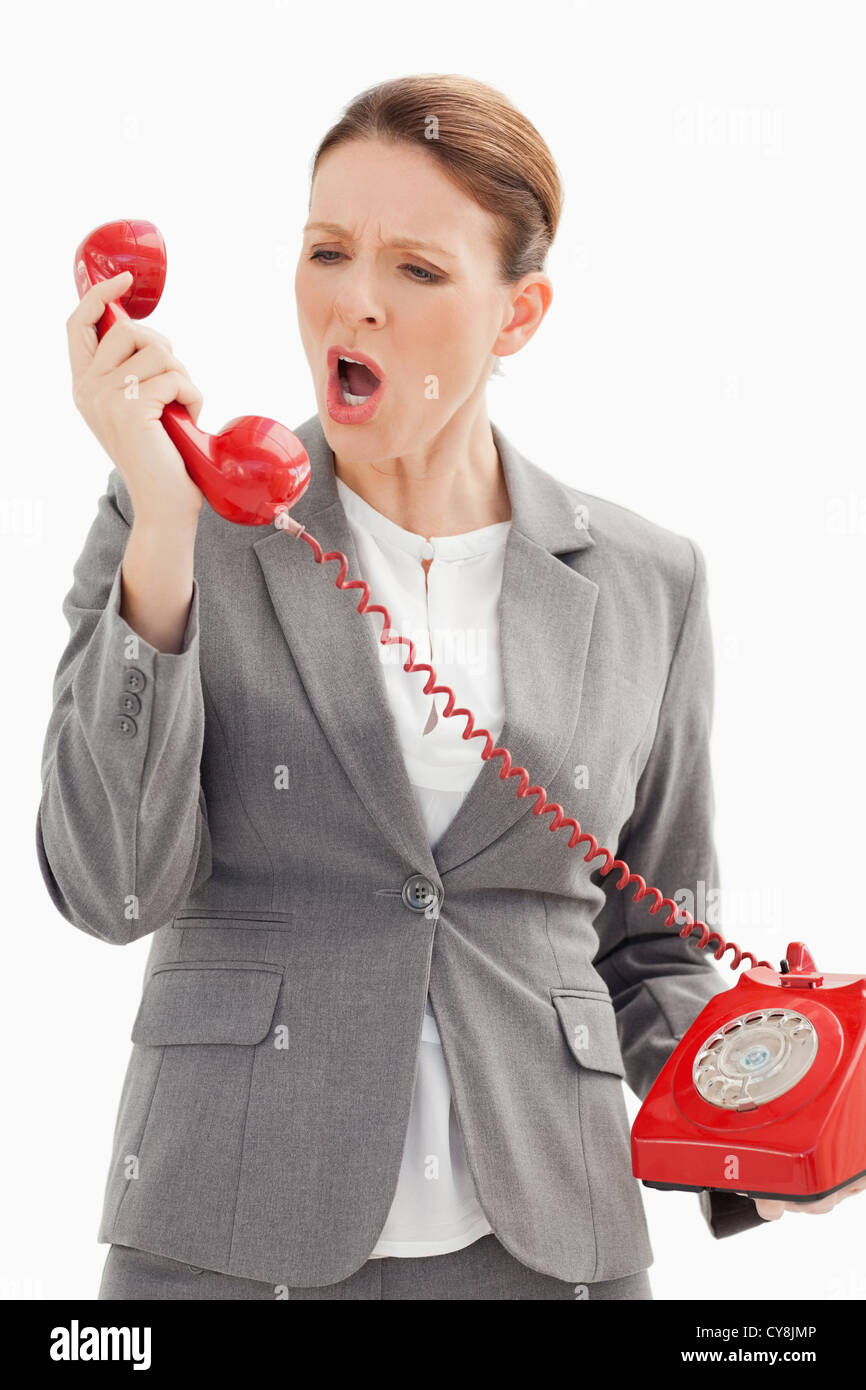 Businesswoman shouts down the phone Stock Photo