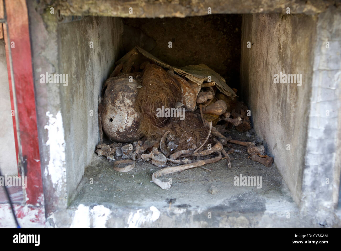 Human remains lay in an open tomb;Calamba cemetery,Cebu City,Philippines Stock Photo