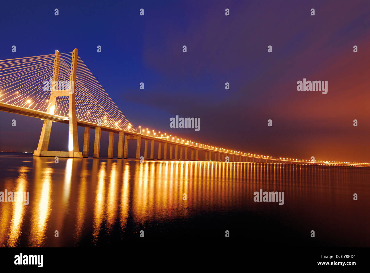 Portugal, Lisbon: Bridge Ponte Vasco da Gama by night with scenic sky Stock Photo