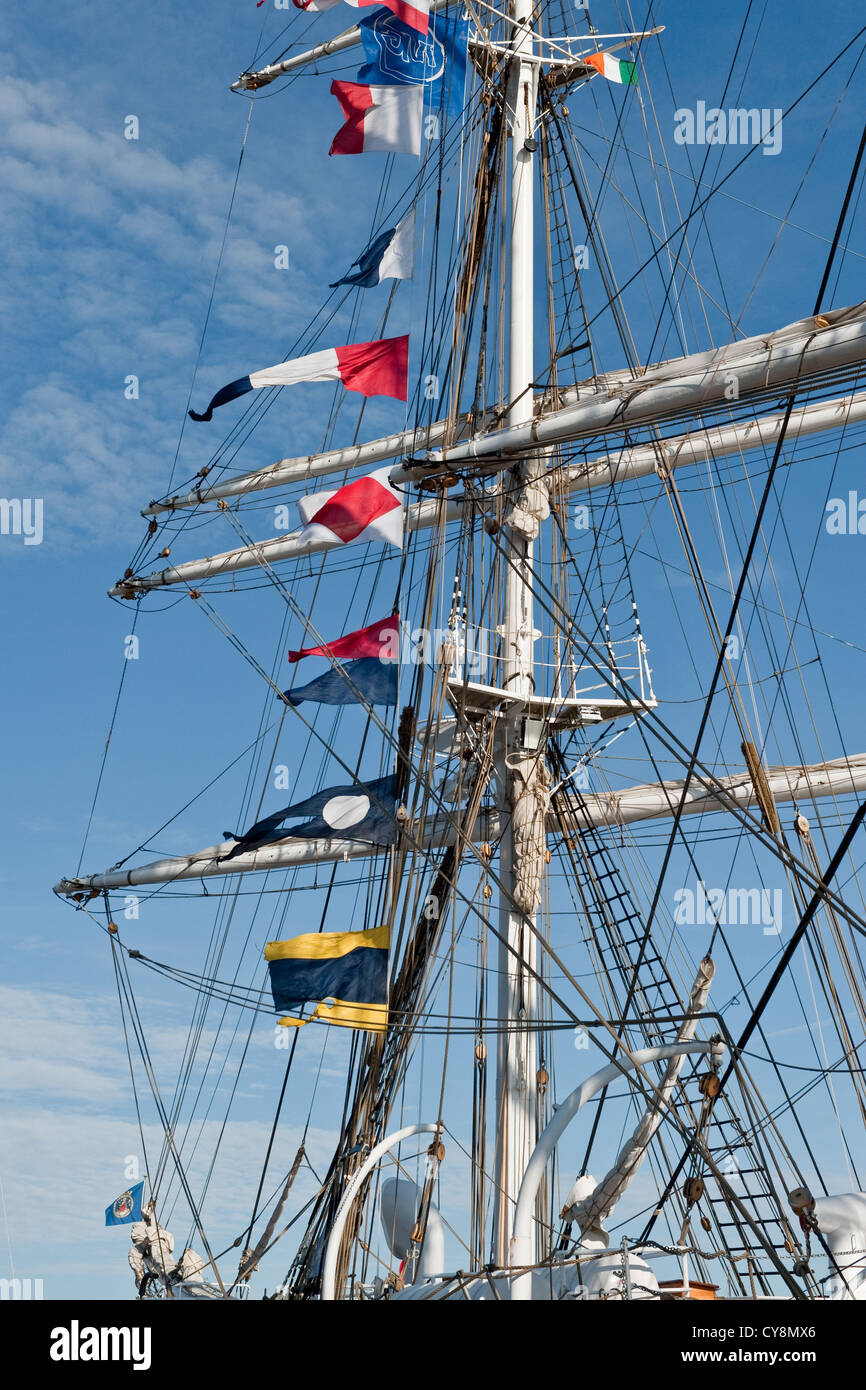 National flags and maritime signal and code pennant flags hoisted on historic tall sailing ships Stock Photo