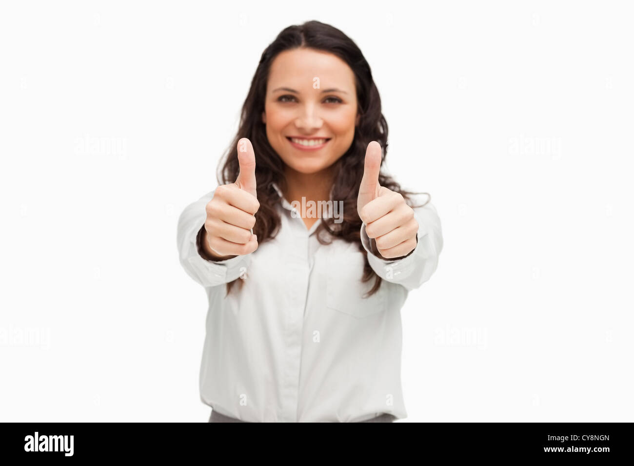 Portrait of a brunette smiling while giving the thumbs up Stock Photo ...