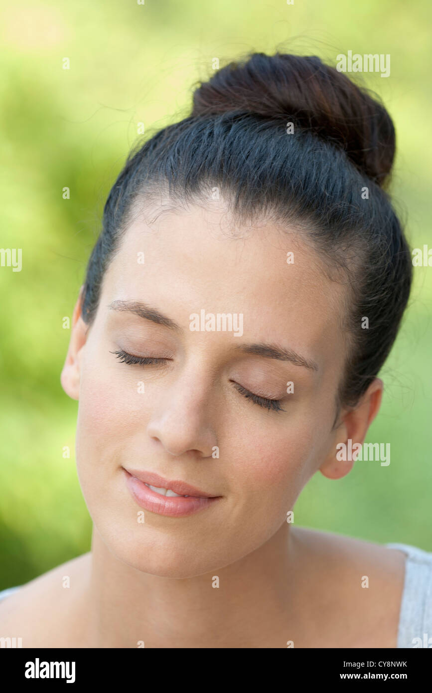 Midadult woman with eyes closed, smiling Stock Photo Alamy