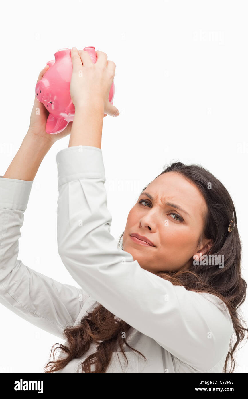 Portrait of a brunette woman holding an empty piggy bank Stock Photo ...