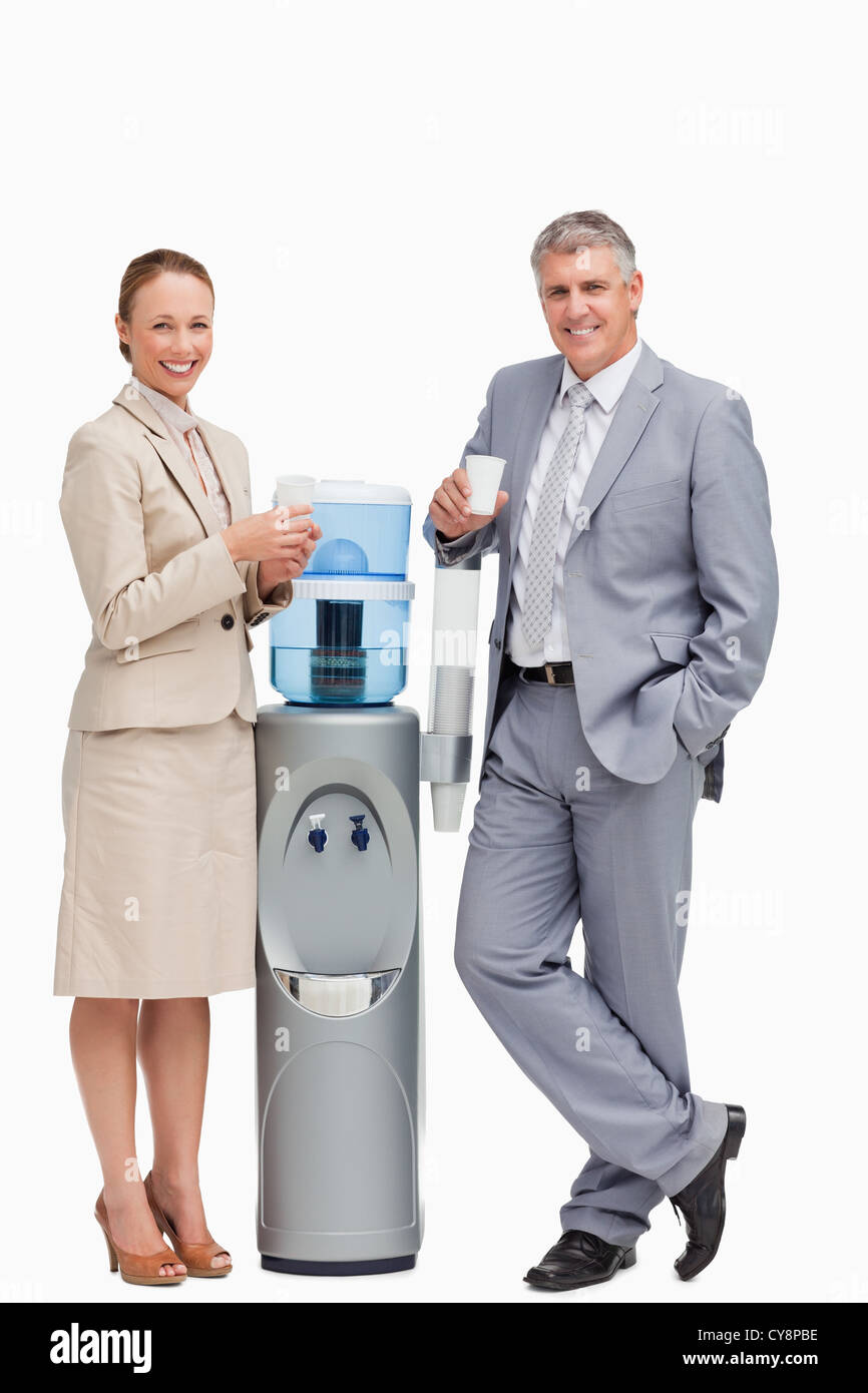 https://c8.alamy.com/comp/CY8PBE/portrait-of-smiling-business-people-next-to-the-water-dispenser-CY8PBE.jpg