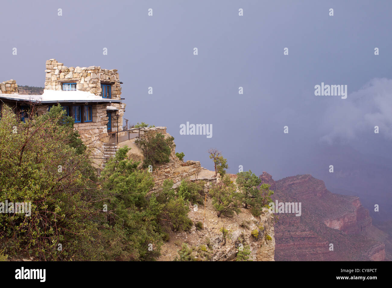 Storm clouds behind the Lookout Studio designed by architect Mary Colter and situated on the South Rim of the Grand Canyon Stock Photo