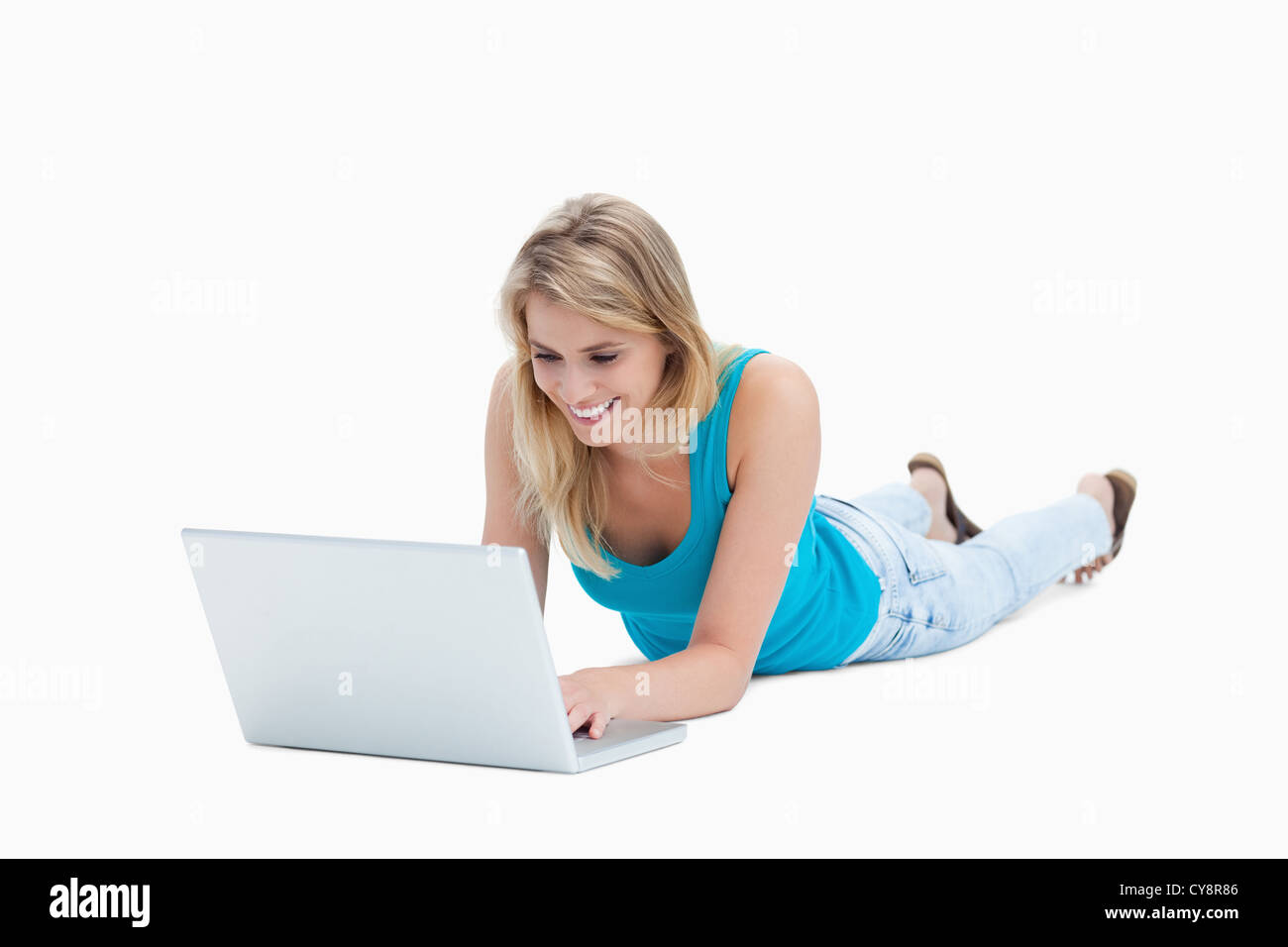 A young woman lying on the floor with a laptop Stock Photo - Alamy