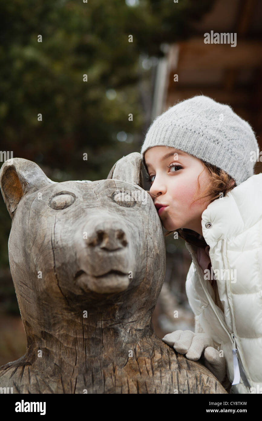 Girl kissing bear statue, portrait Stock Photo Alamy