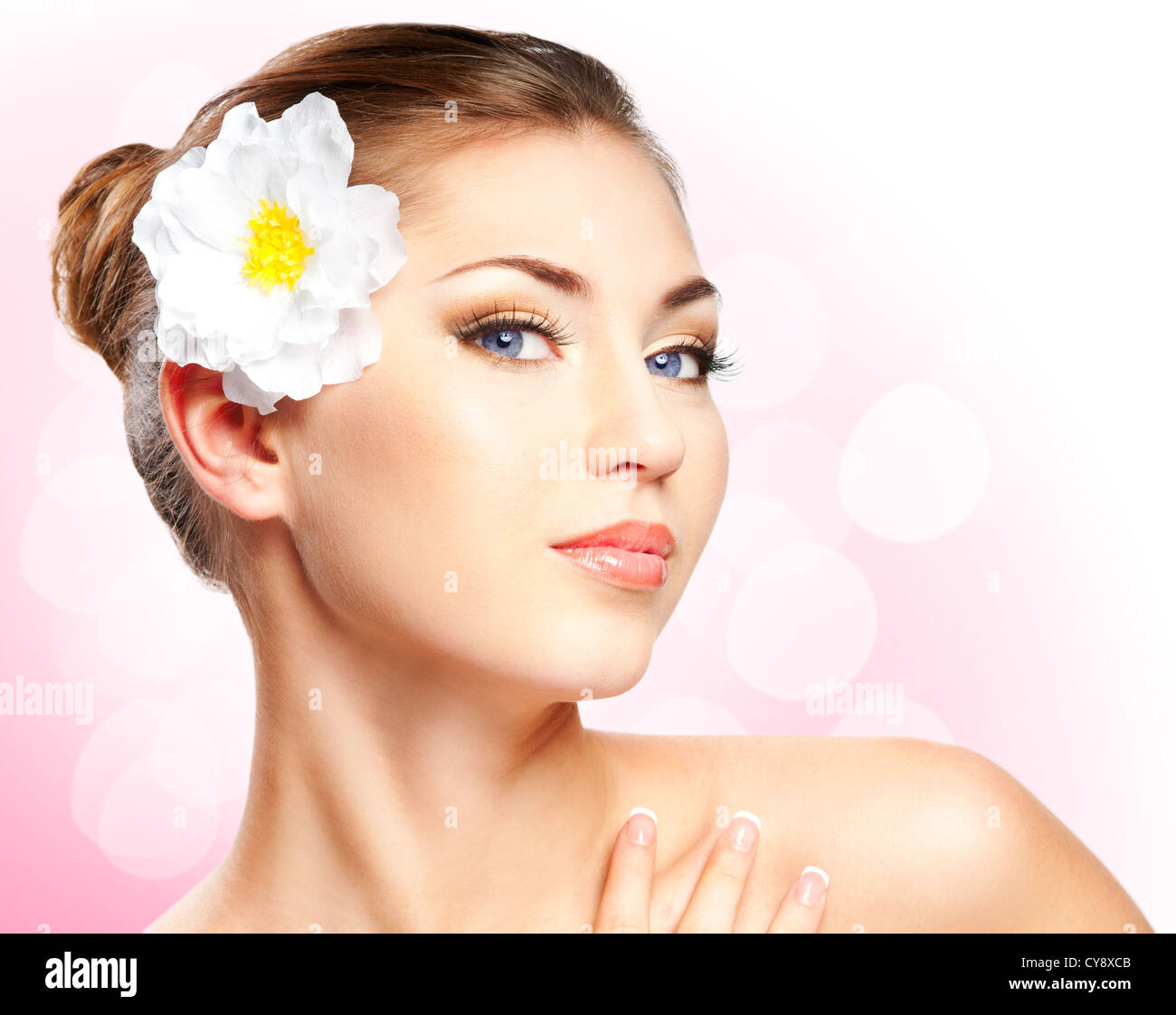 Closeup beautiful woman face with flower isolated on white background