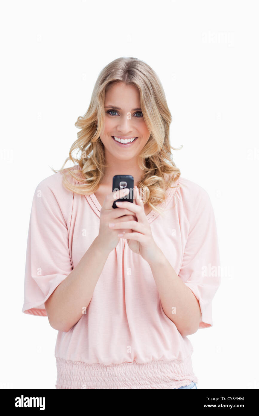 A woman holding a mobile phone is looking at the camera Stock Photo Alamy