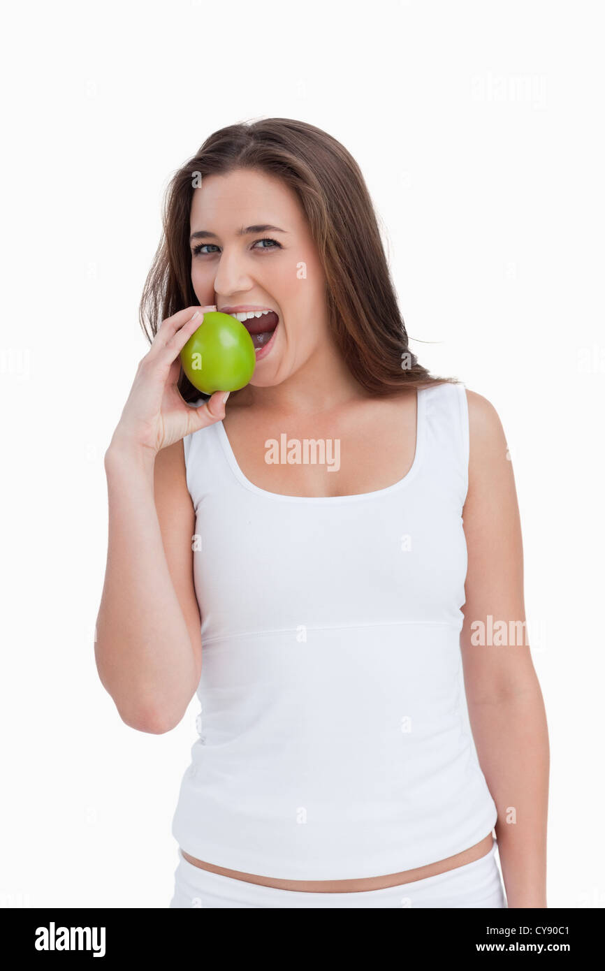 Smiling woman eating a green apple Stock Photo Alamy