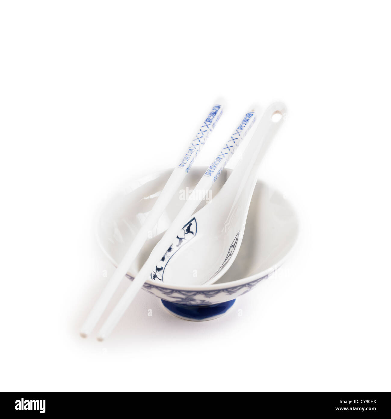 Chinese chopsticks and soup spoon in a bowl on white background Stock
