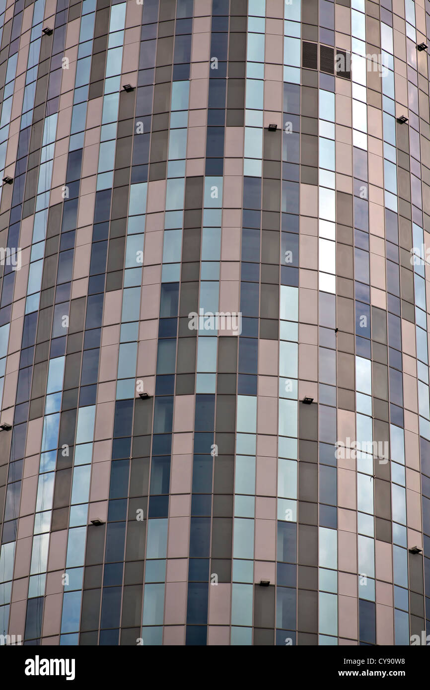 A tall round office building against a cloudy sky Stock Photo - Alamy