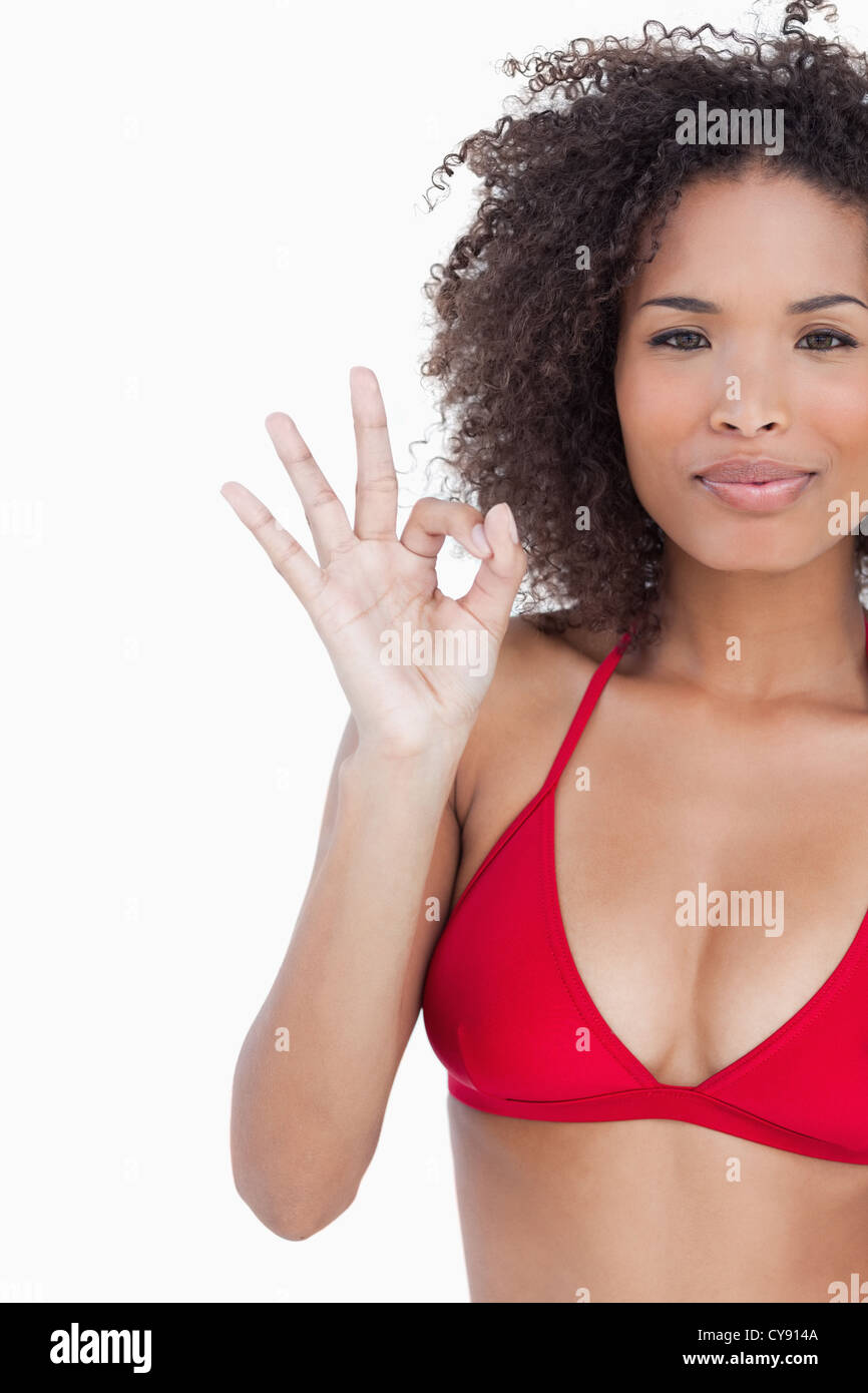 Serious young brunette showing the ok sign Stock Photo