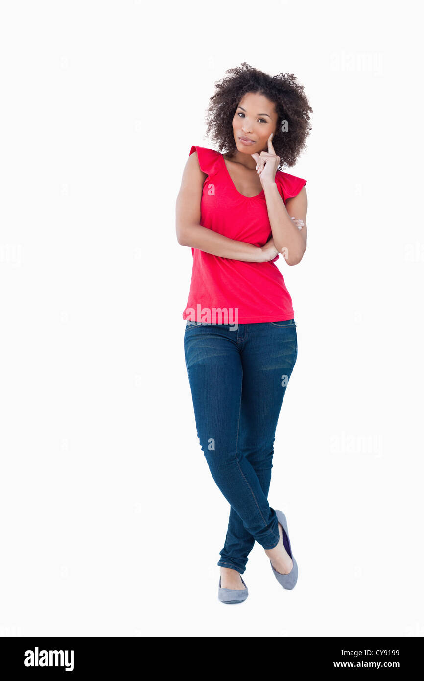 Young thoughtful woman standing upright Stock Photo