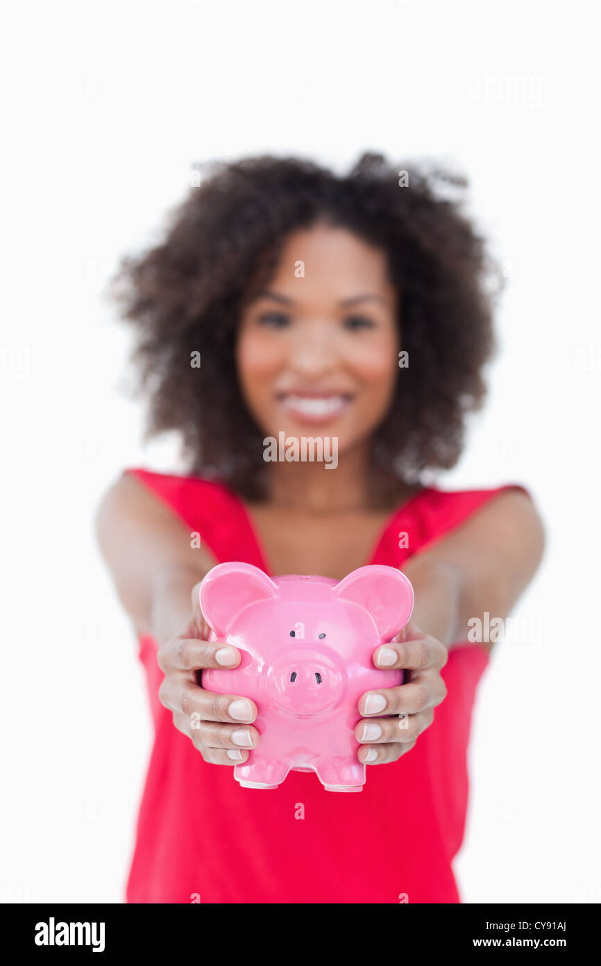 Pink piggy bank being held by a brunette woman Stock Photo - Alamy