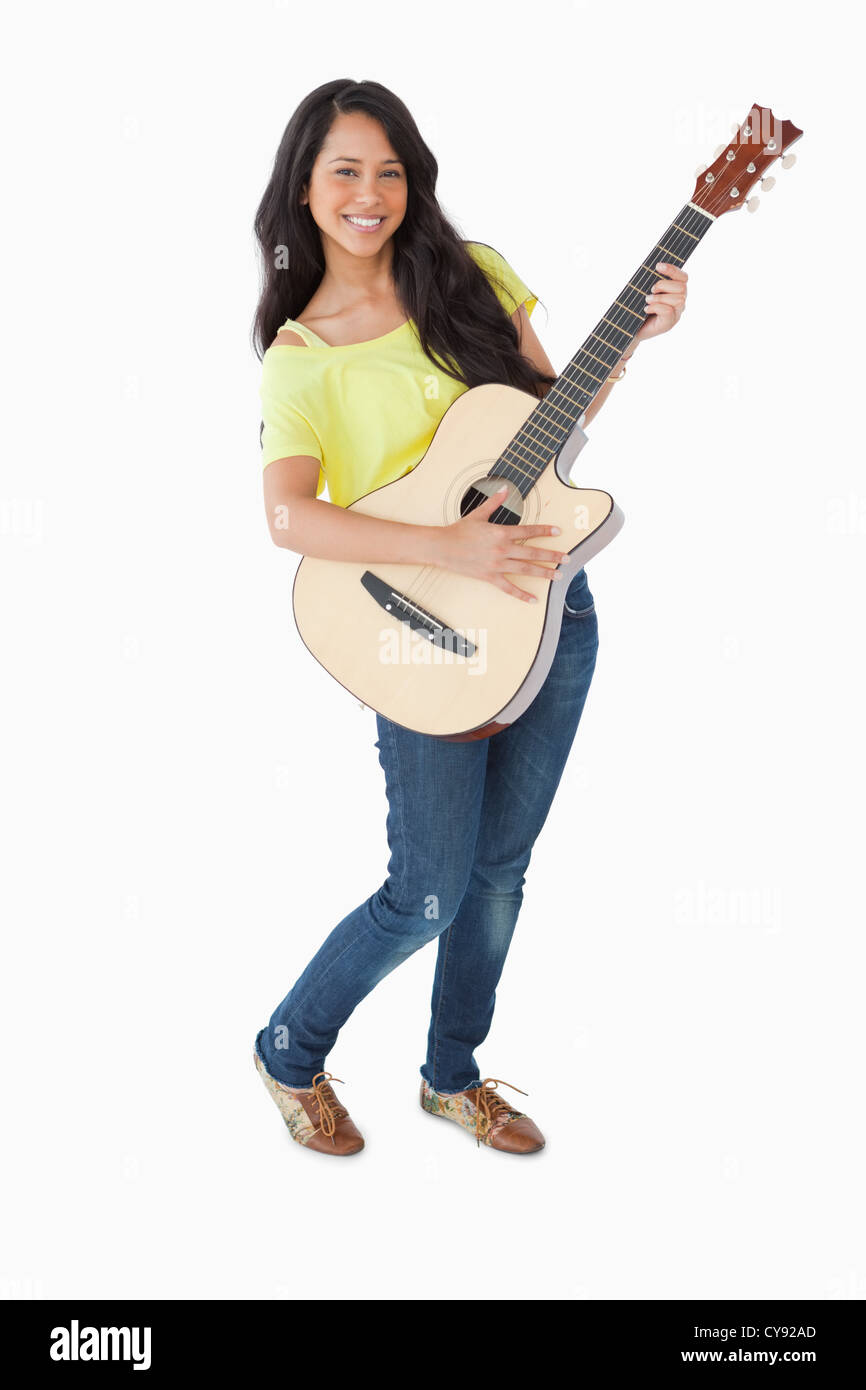 Young woman holding a guitar Stock Photo - Alamy