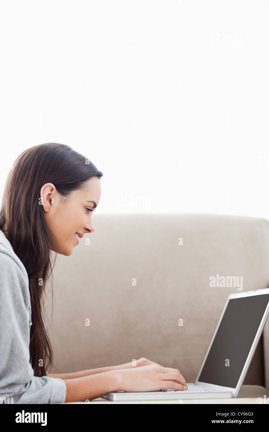 Close up shot of a woman lying on the couch with her laptop Stock Photo ...