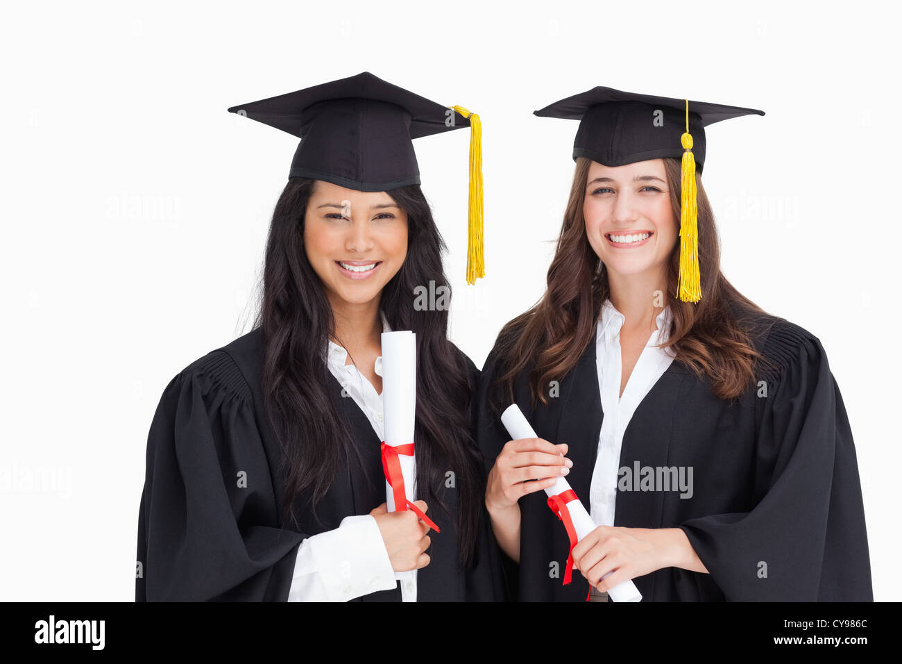 Two friends stand together after graduating Stock Photo