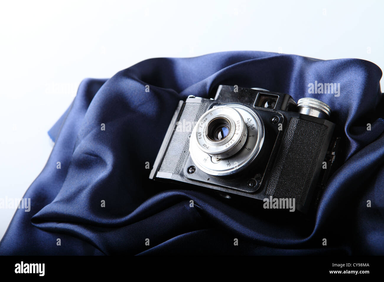close-up of vintage camera on blue satin background Stock Photo
