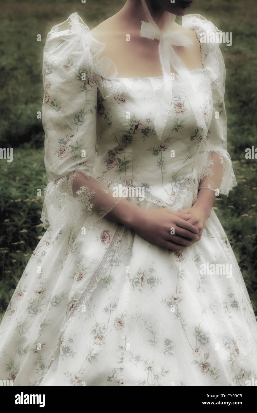 a woman with a period dress on a meadow Stock Photo