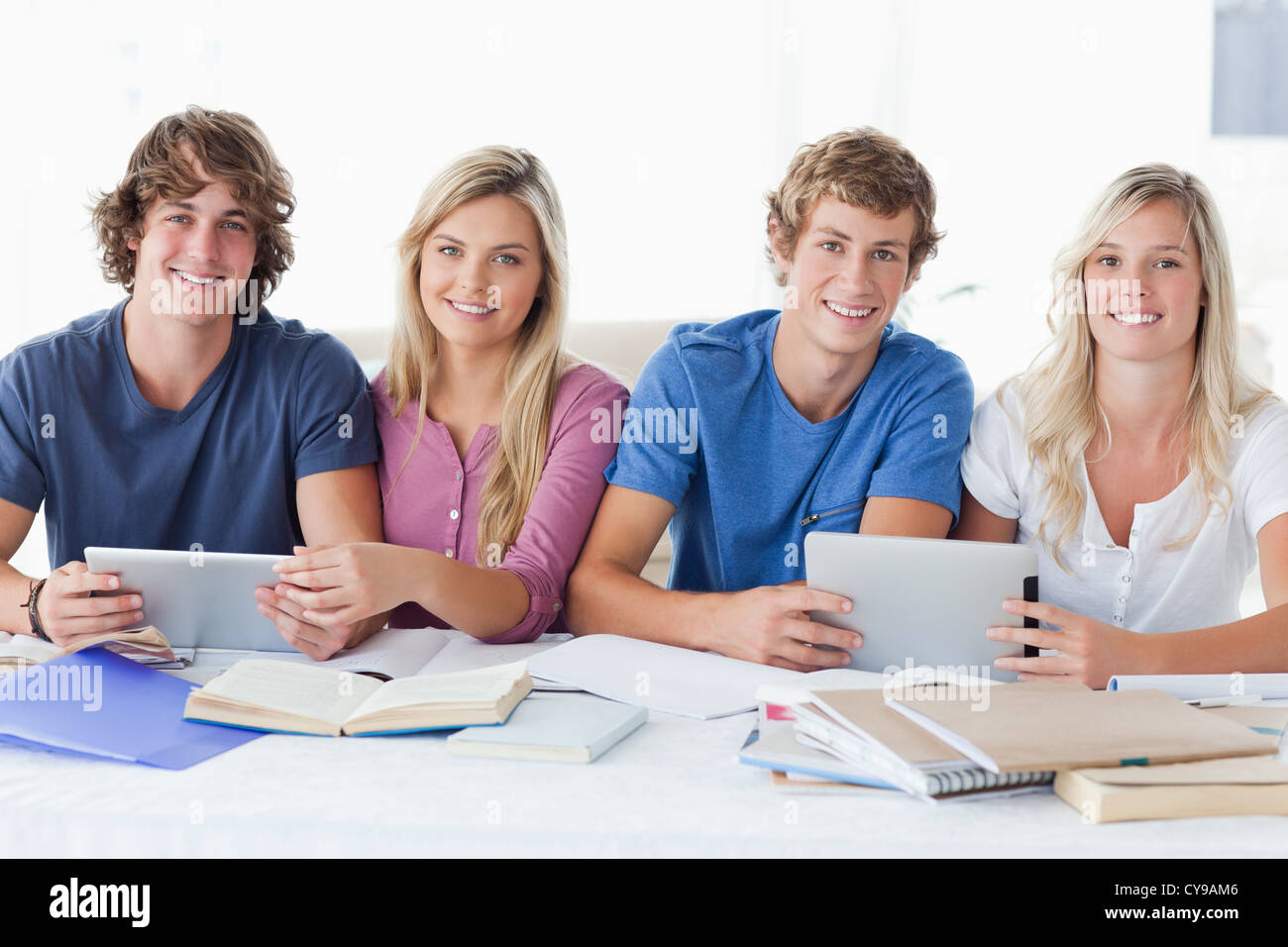 A smiling group of students looking at the camera Stock Photo - Alamy