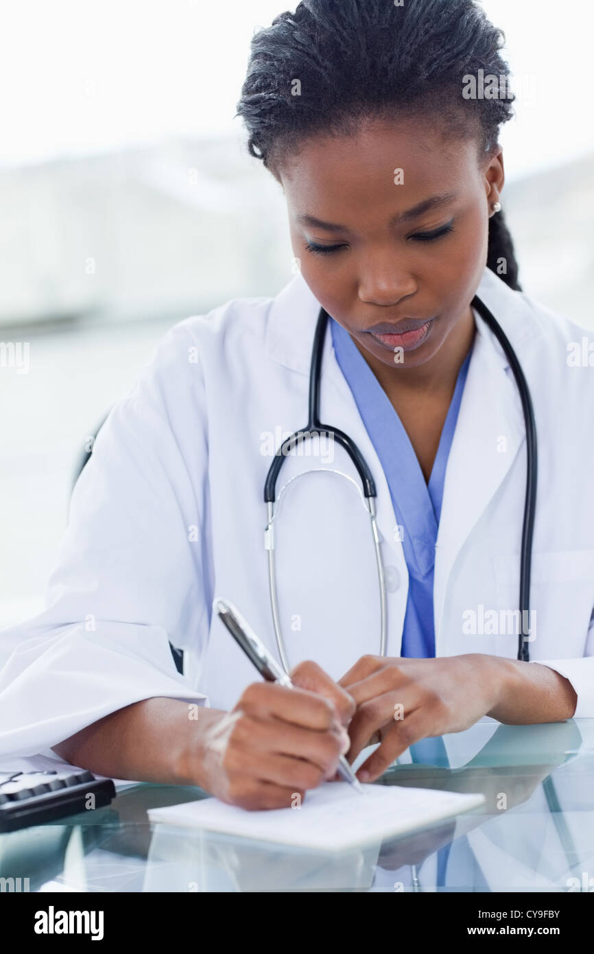 Portrait of a female doctor writing a prescription Stock Photo - Alamy