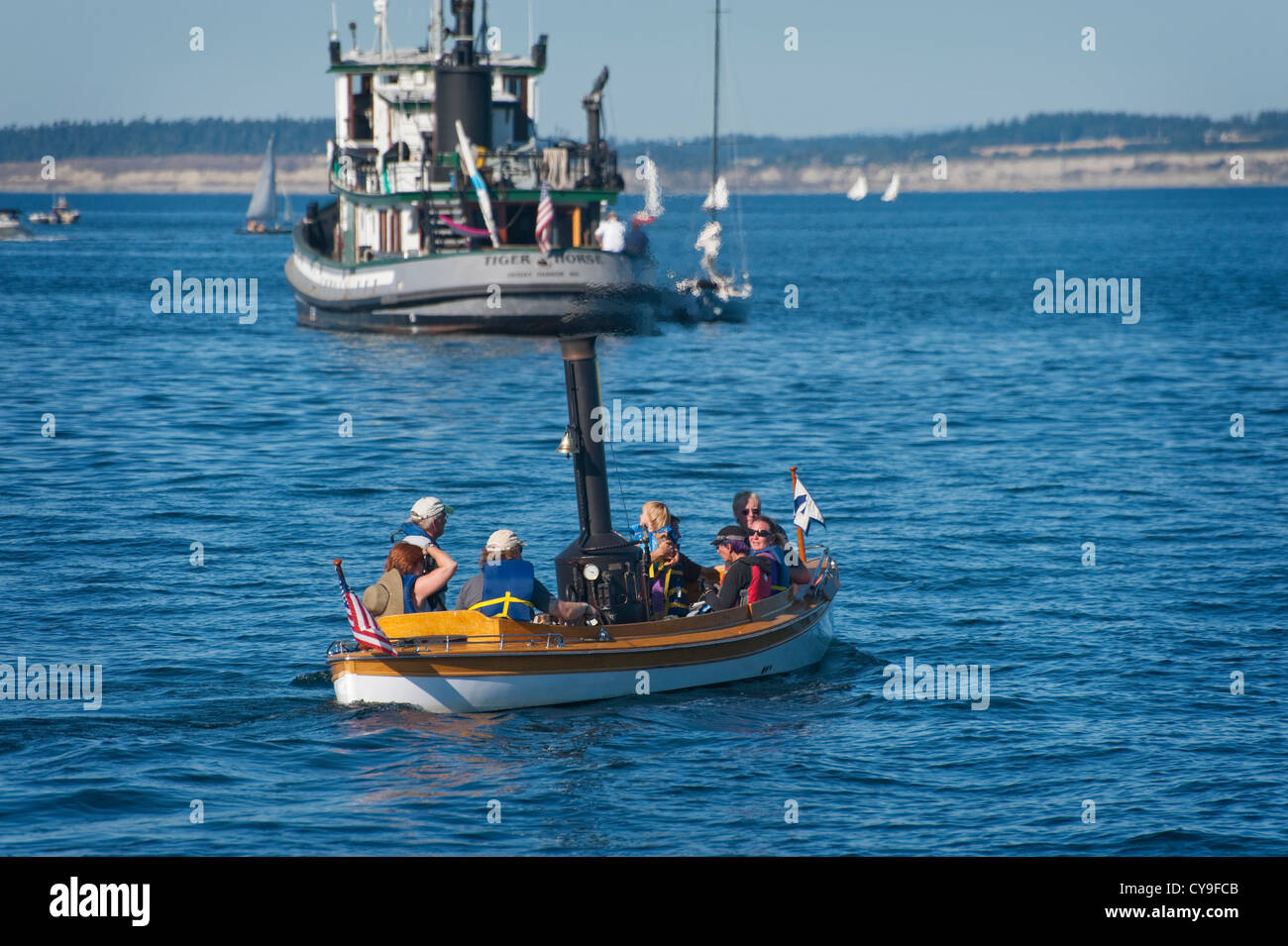A stem powered launch takes visitors to Port Townsend out for a ride in the harbor during the summer Wooden Boat Festival. Stock Photo