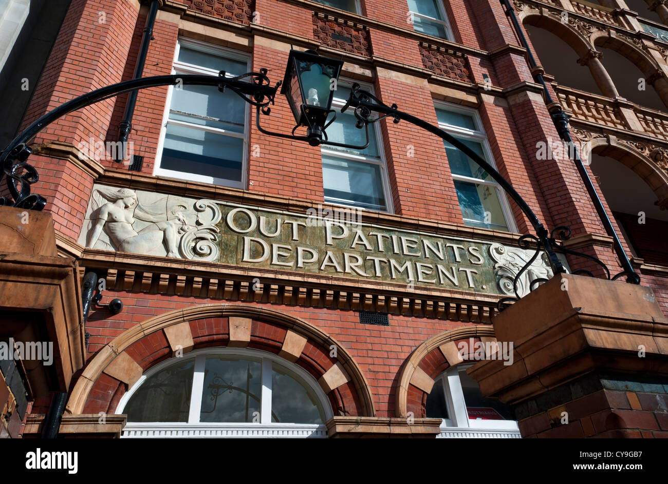 Ornate Victorian 'Out Patients Department ' sign outside entrance to NHS hospital London UK Stock Photo