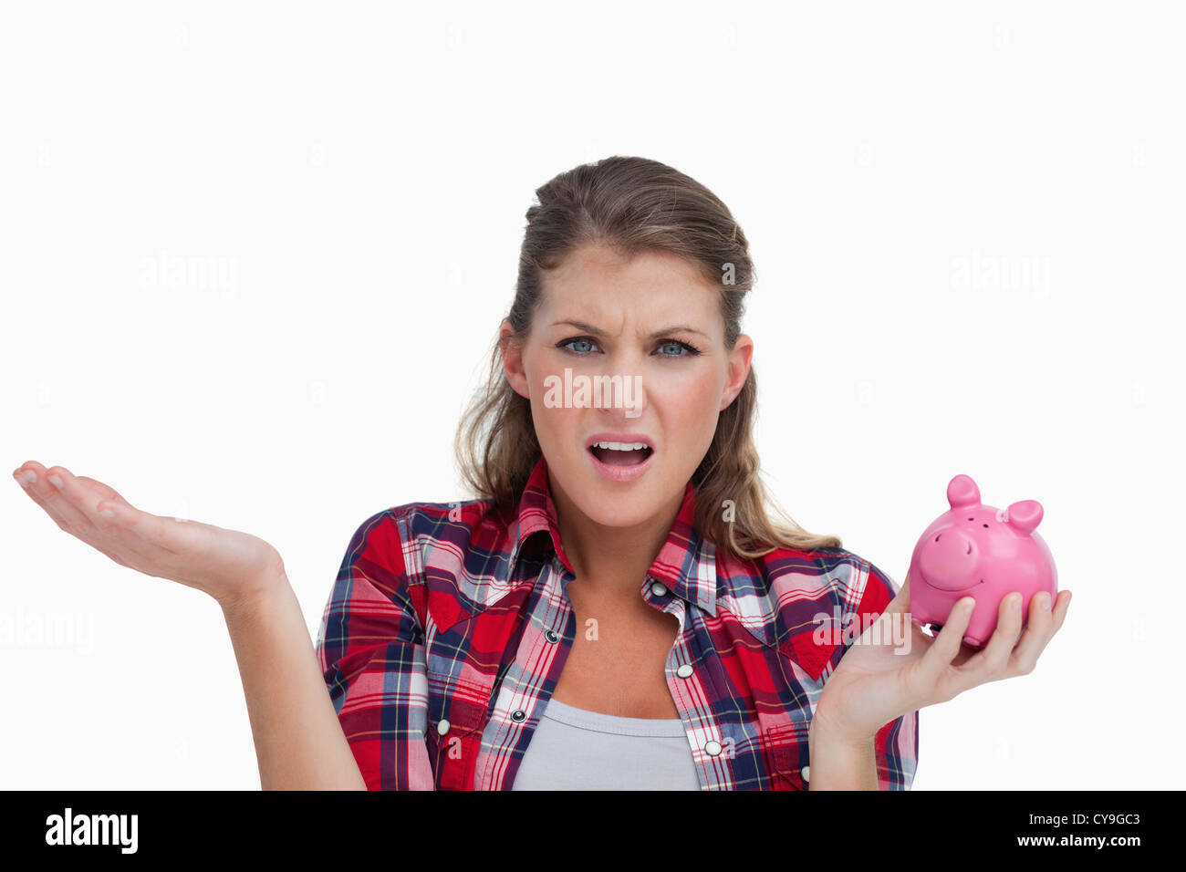 Broke woman holding a piggy bank Stock Photo - Alamy