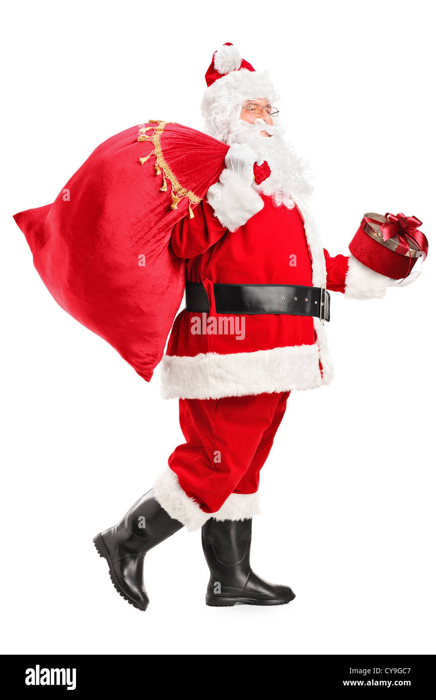 Full length portrait of a Santa Claus walking with bag and gift in his ...