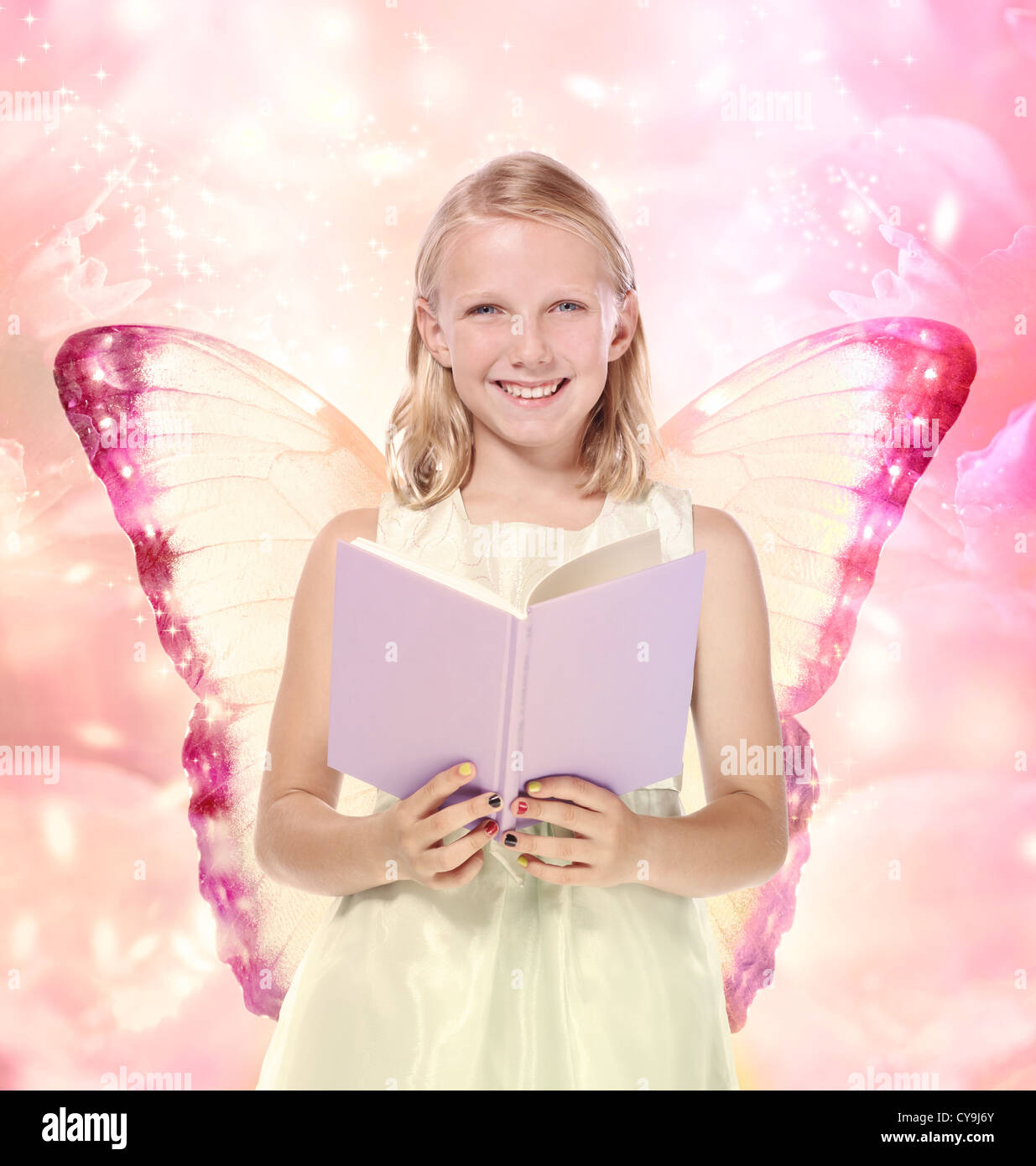 Happy young girl reading a book - fantasy, fiction Stock Photo