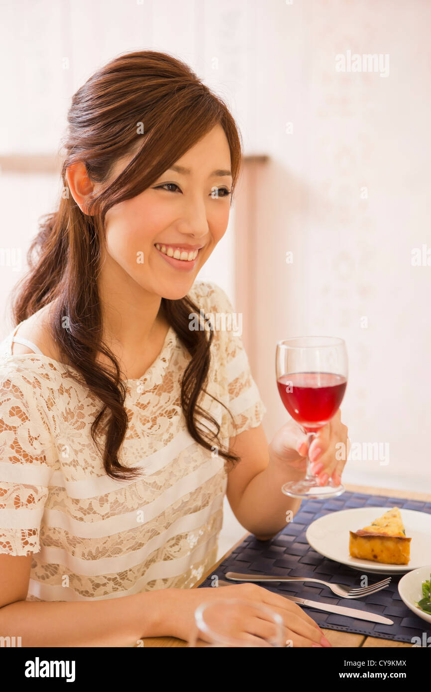 Young Woman Enjoying a Glass of Wine Stock Photo