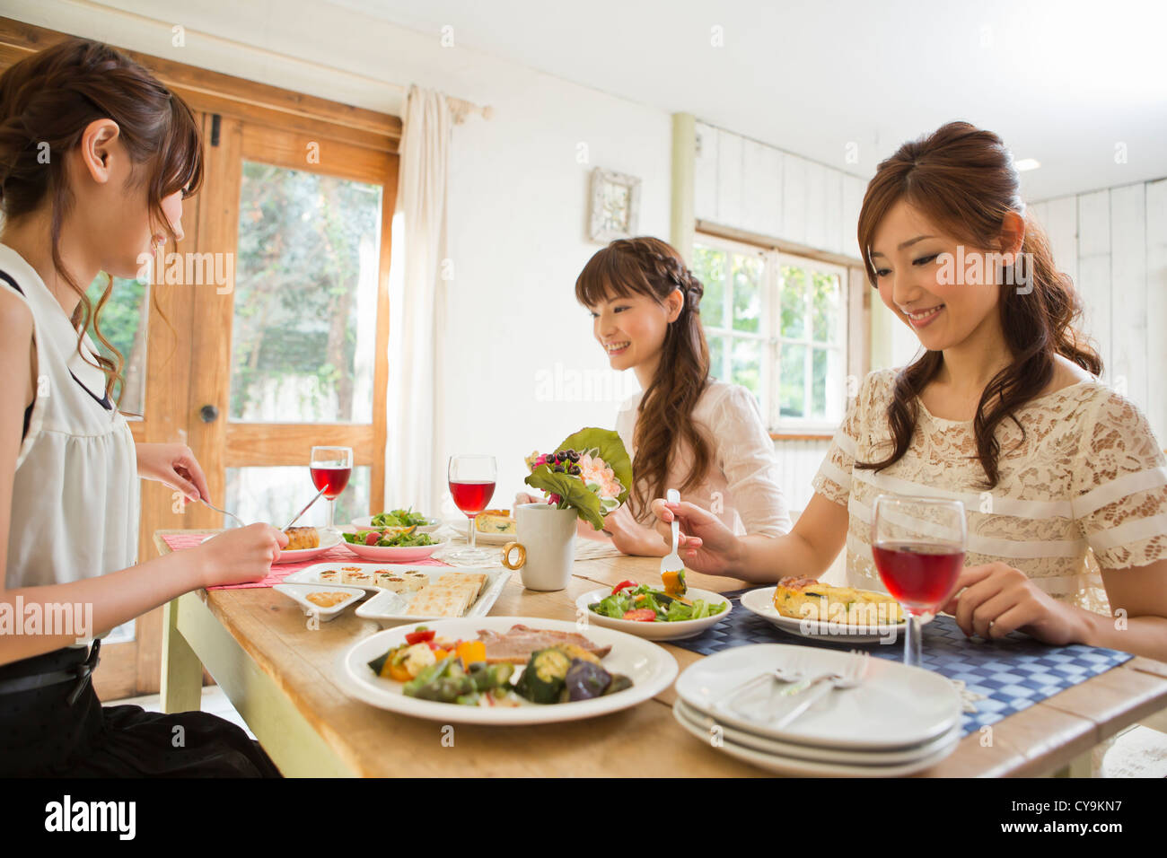 Three Young Women Enjoying Party Stock Photo