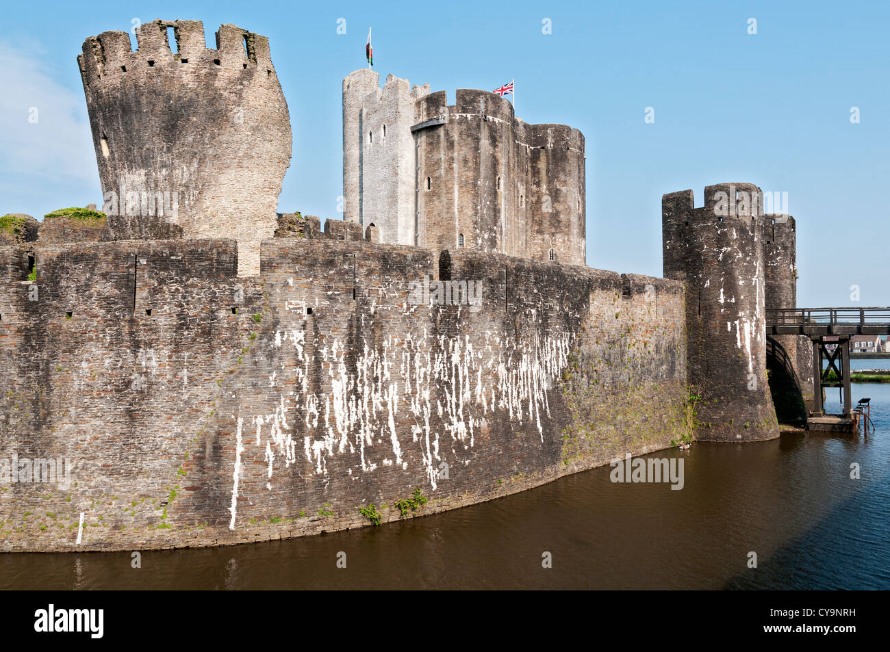 Wales, Caerphilly Castle, construction began 1268, moat, Welsh flags Stock Photo