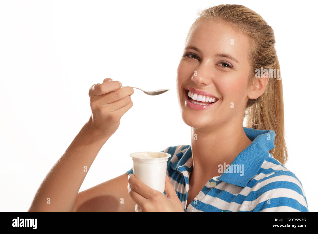 young woman eating yogurt on white background Stock Photo Alamy