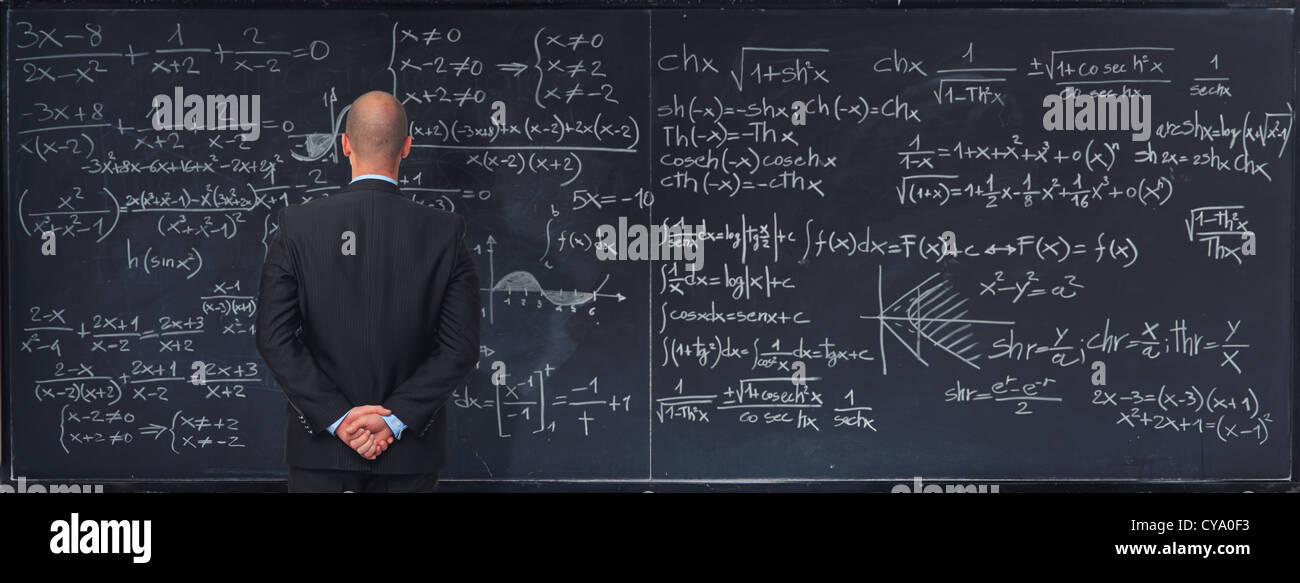 man and classic blackboard with math text Stock Photo