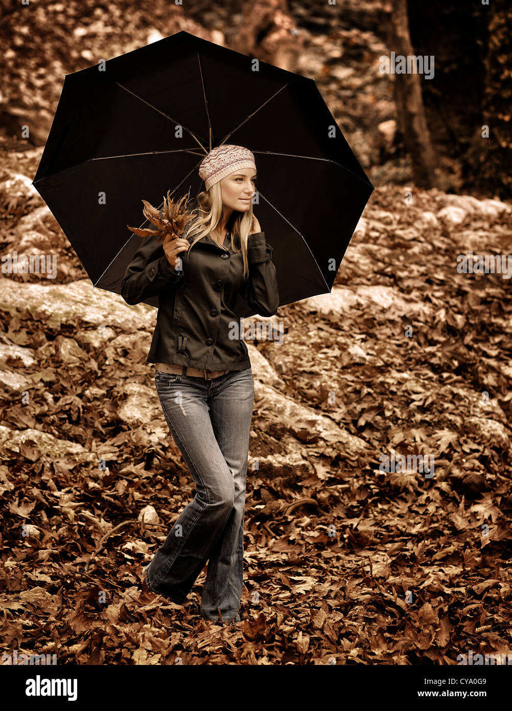 Retro style image of beautiful girl standing under black umbrella in ...