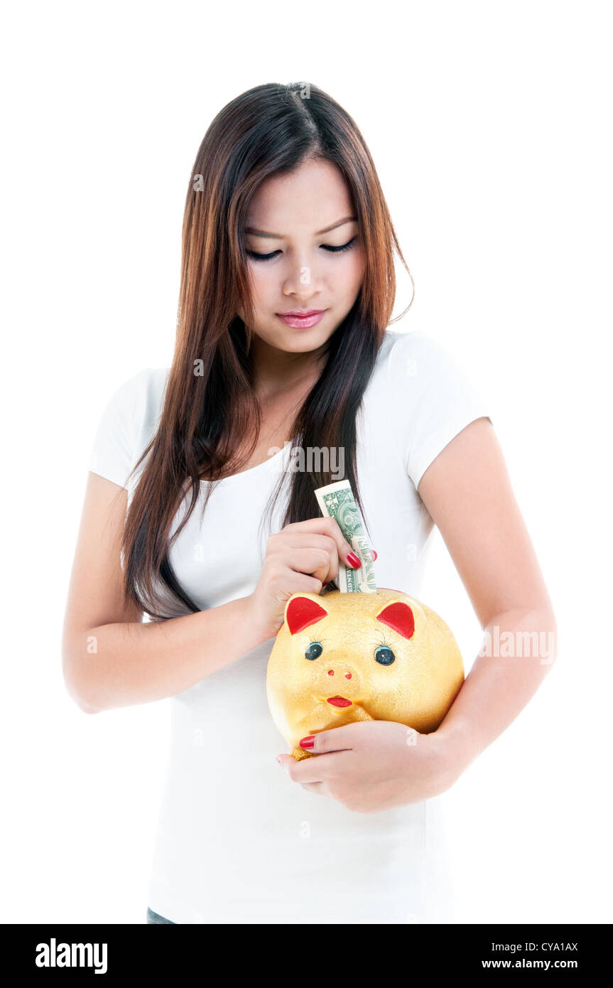 Pretty young woman putting money into piggy bank, portrait Stock Photo ...