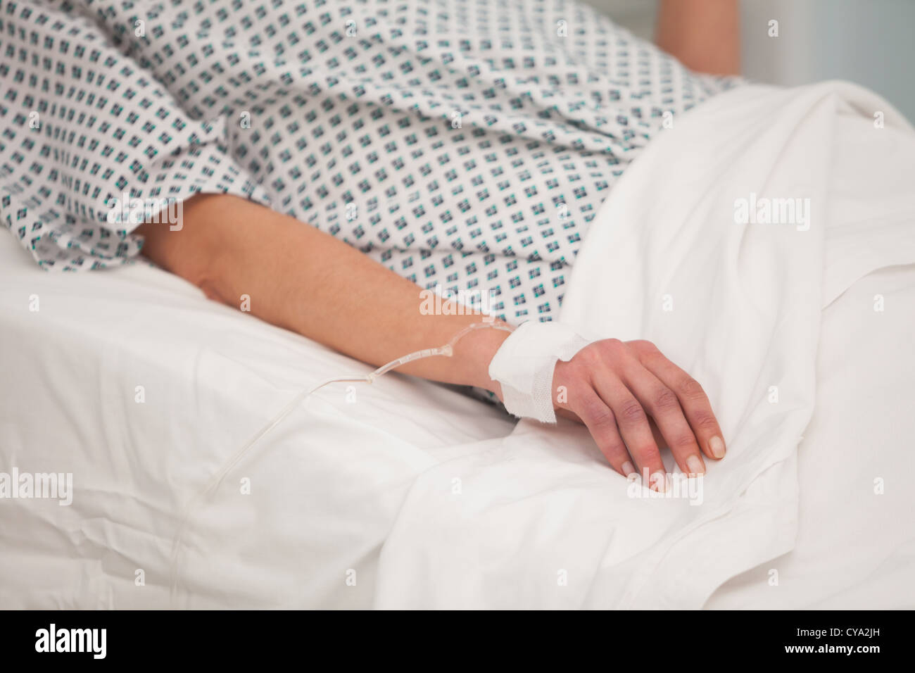 Arm attached to intravenous drip Stock Photo