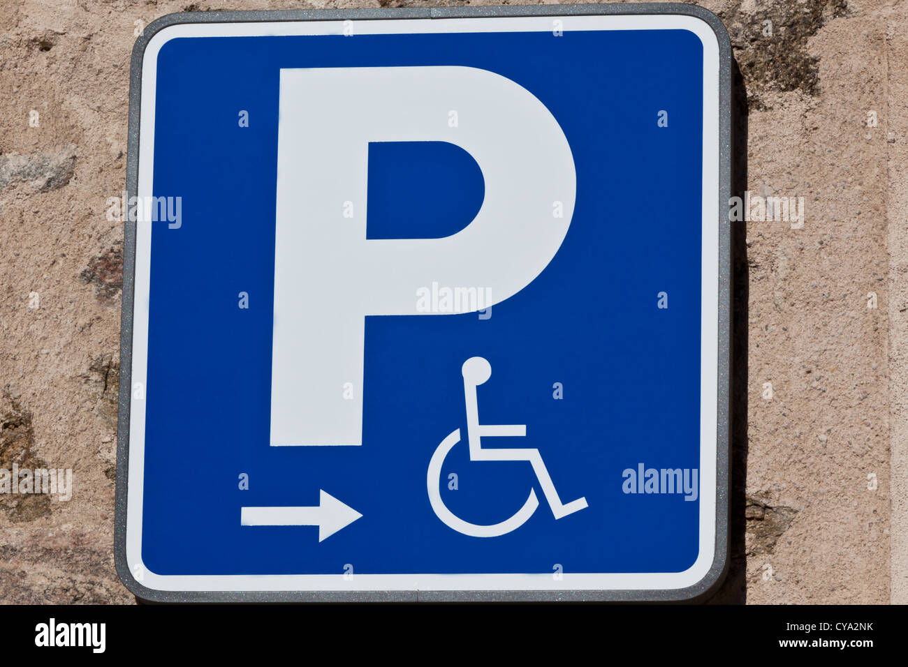 A handicaped parking sign on a house wall Stock Photo