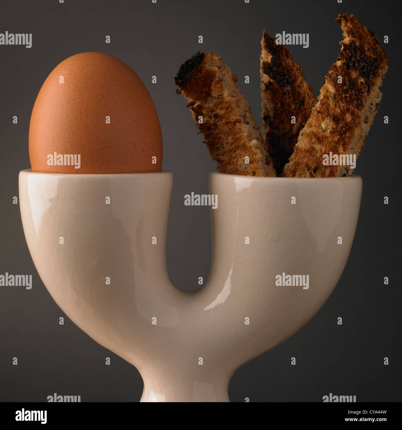 Breakfast boiled egg and soldiers of toast in a double eggcup Stock Photo
