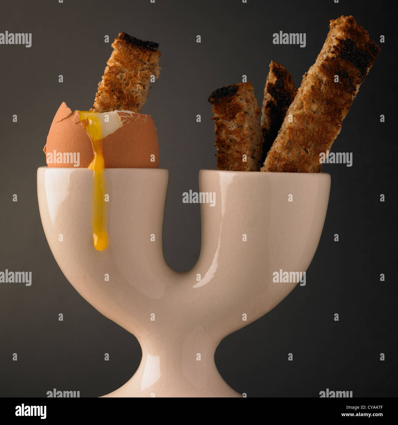 Breakfast soft boiled egg and soldiers of toast in a double eggcup Stock Photo