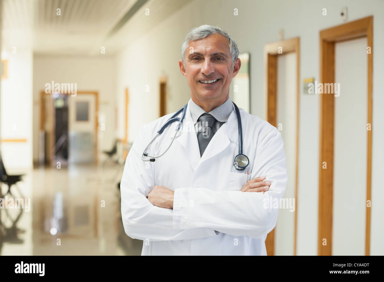 Doctor smiling in the corridor Stock Photo - Alamy