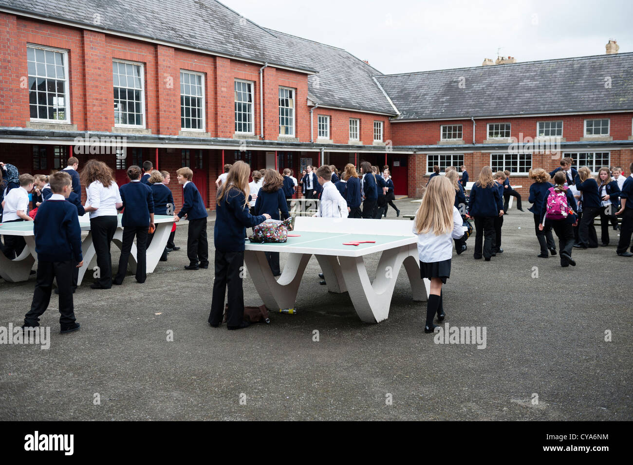 Pupils at breaktime in the schoolyard of a secondary comprehensive school , Wales UK Stock Photo