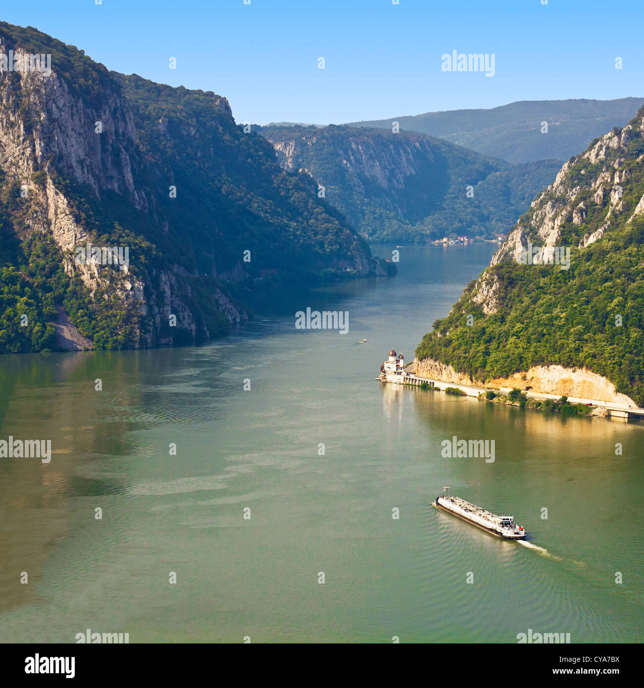 The ship passes through the narrowest part of the gorge on the Danube between Serbia and Romania, also known as the Iron Gate. Stock Photo