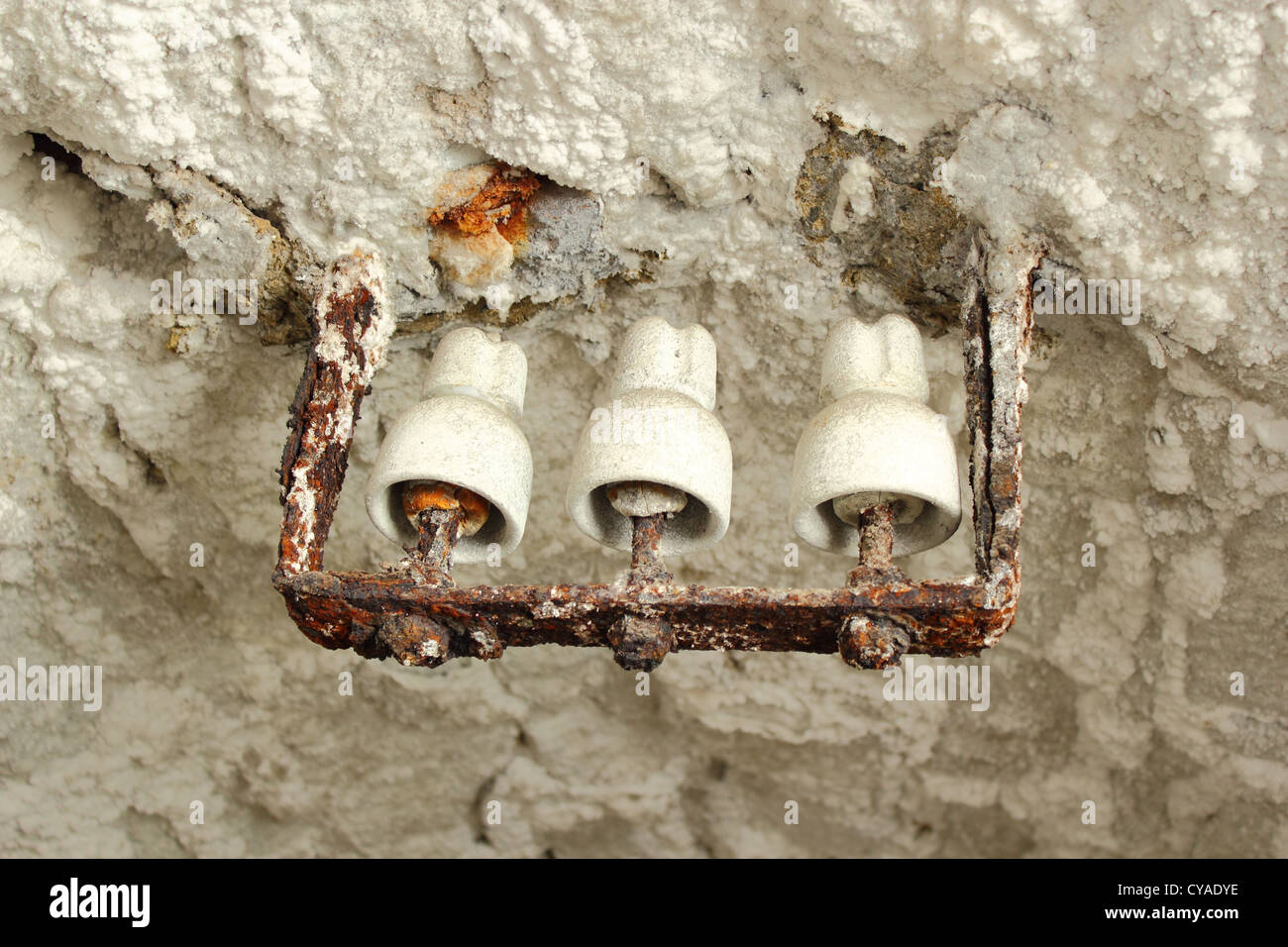 old electricity equipment in a salt mine ; the salt has drained off